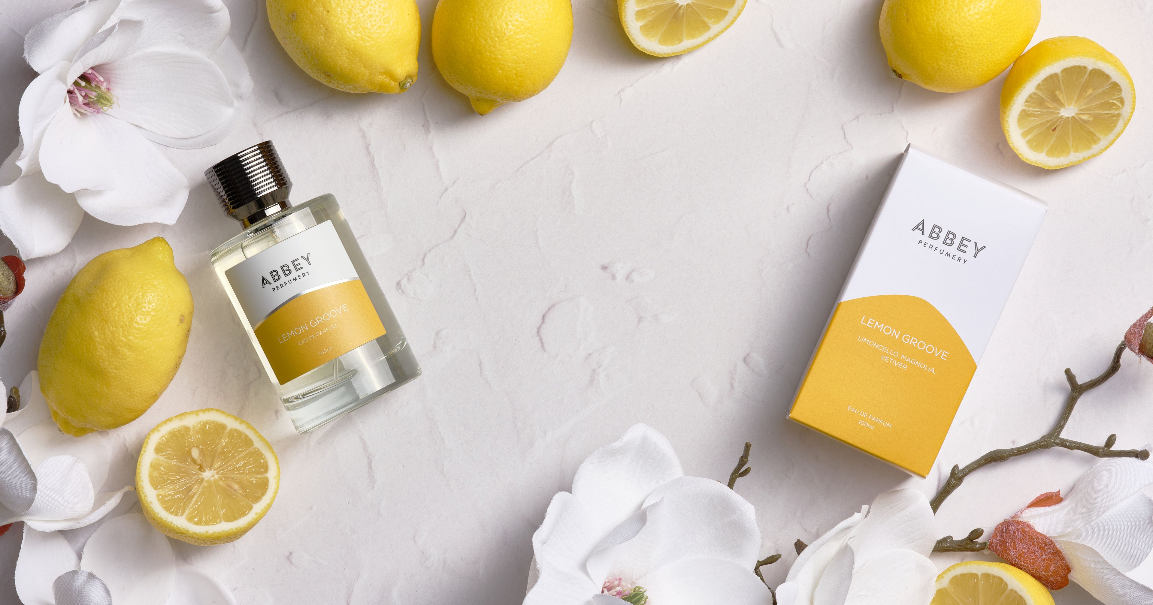 Abbey perfume bottle and packaging with lemons and flowers on a light background